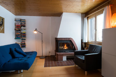 Stube mit kleiner Bibliothek und Cheminéeofen